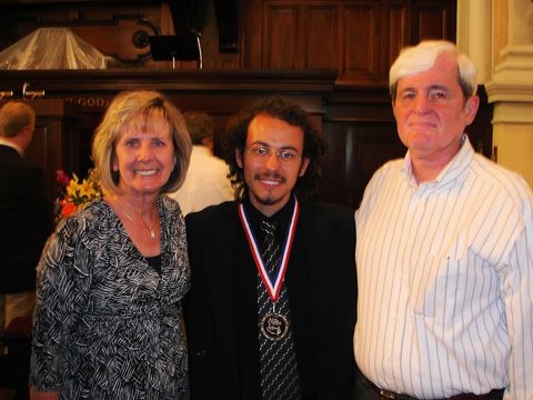 Dr. Costa accepting a guitar competition award